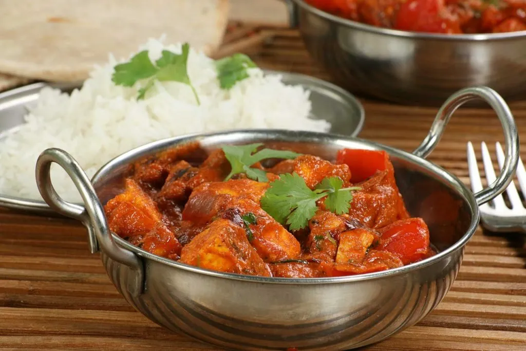A karahi curry served with steamed basmati rice and warm naan bread
